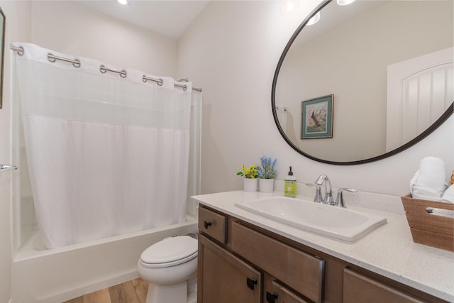 bathroom featuring shower / bath combo, vanity, toilet, and wood finished floors