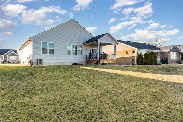 back of house with a residential view, a yard, a wooden deck, and central air condition unit