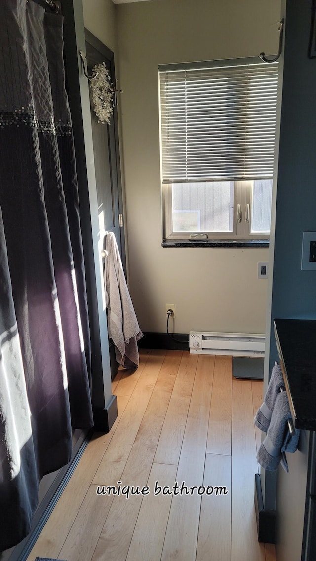 bathroom featuring a baseboard radiator and wood finished floors