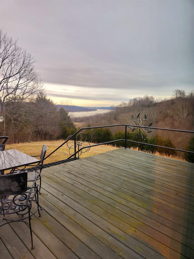 deck at dusk featuring a mountain view