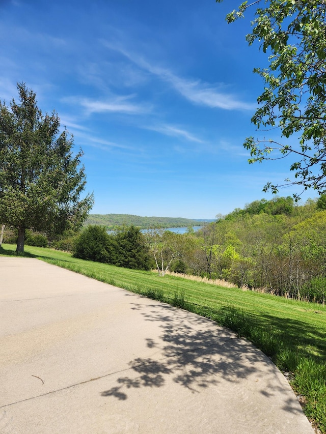 view of property's community featuring a water view and a yard