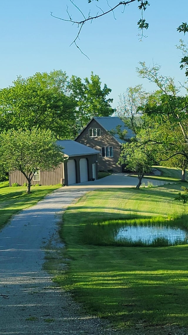 5433 Mary Ingles Hwy, Foster, KY 41043 - view of home's community with asphalt driveway, a garage, a water view, and a lawn