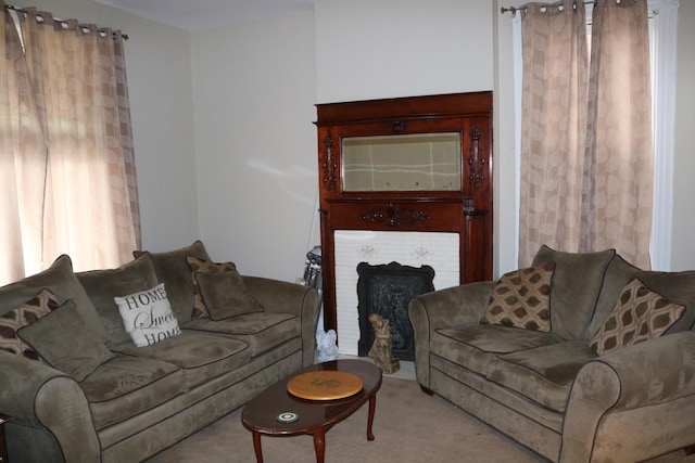 carpeted living area featuring a brick fireplace