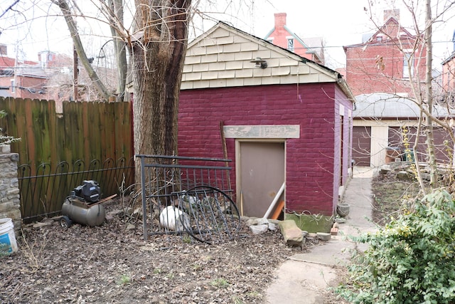 view of outbuilding featuring fence