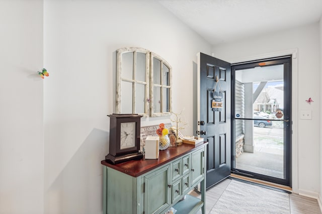 interior space with baseboards and light wood-style floors