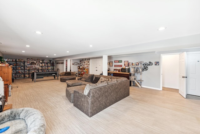 living room with recessed lighting, baseboards, and light wood-style flooring