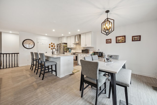 dining area with recessed lighting, baseboards, and a notable chandelier