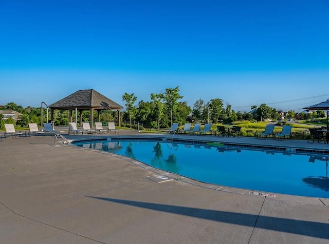 pool featuring a gazebo and a patio area