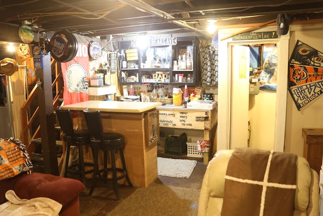 bar featuring a dry bar and concrete flooring