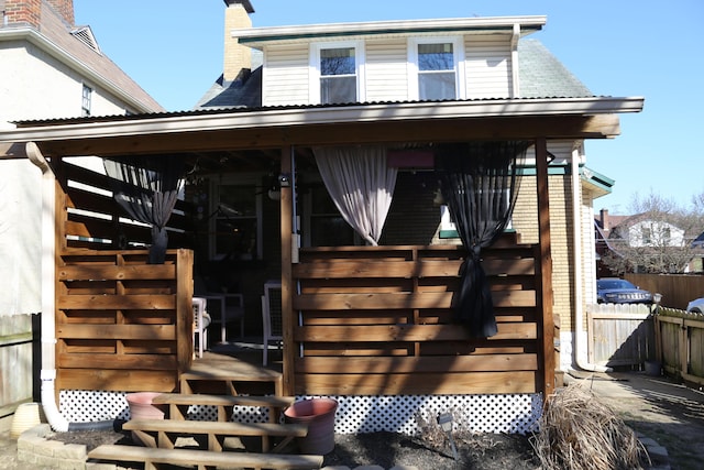 exterior space with a chimney and fence