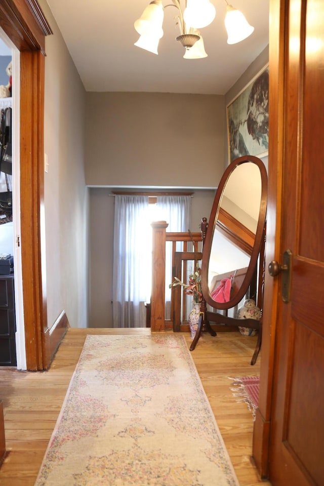 interior space with a notable chandelier and light wood-style floors