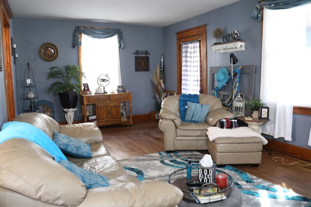 living area featuring baseboards and wood finished floors