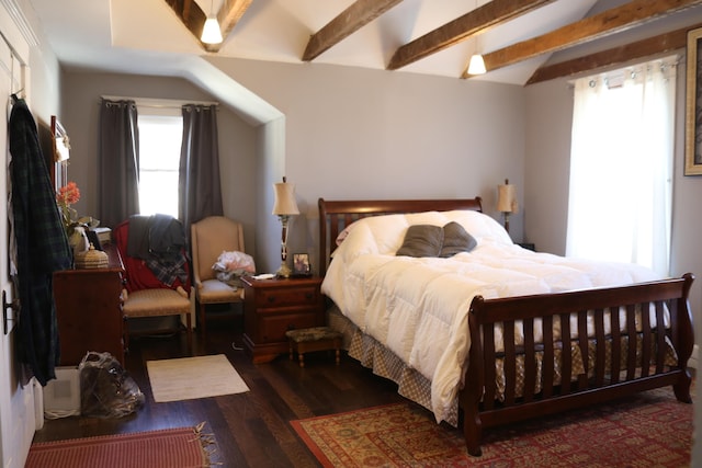 bedroom with multiple windows, wood finished floors, and vaulted ceiling with beams