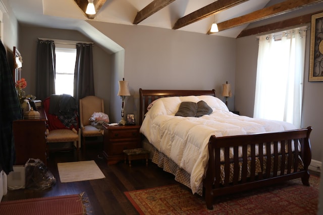 bedroom featuring multiple windows, lofted ceiling with beams, and wood finished floors