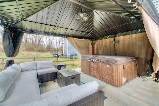 view of patio featuring a hot tub, outdoor lounge area, and a gazebo