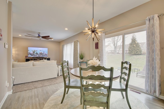 dining space with baseboards, wood finished floors, visible vents, and recessed lighting