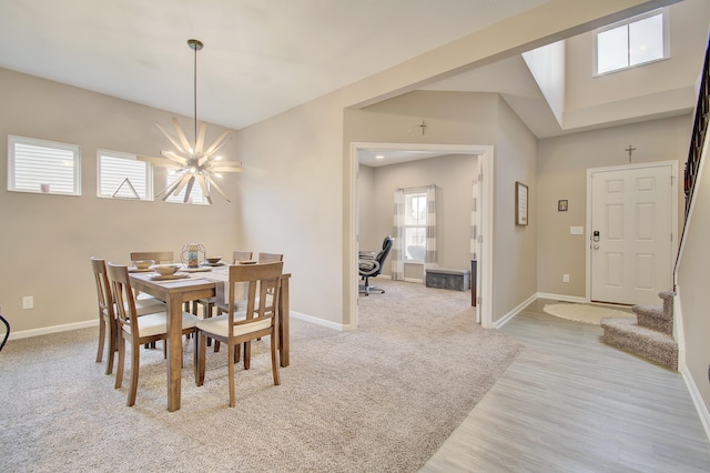 dining space with a notable chandelier, stairway, light wood-type flooring, and baseboards