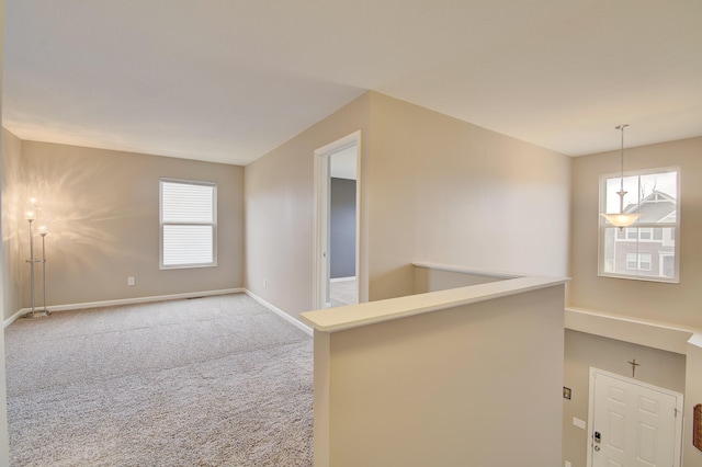 empty room with carpet and baseboards