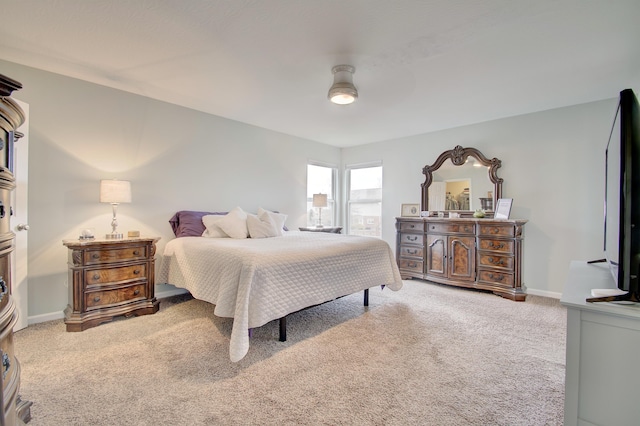 carpeted bedroom featuring a ceiling fan and baseboards