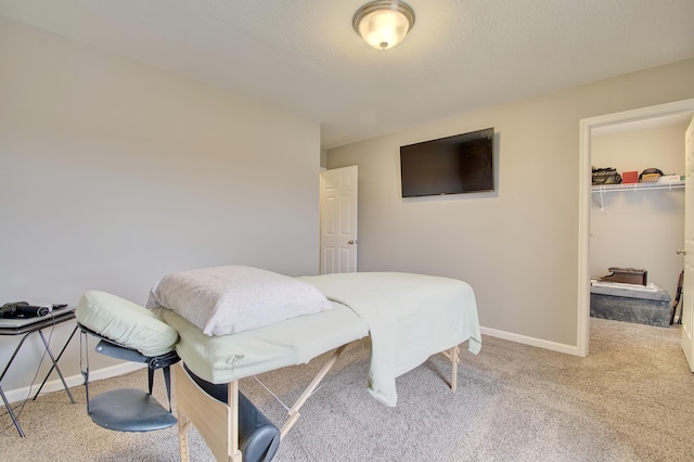 bedroom featuring a closet, carpet flooring, a spacious closet, and baseboards