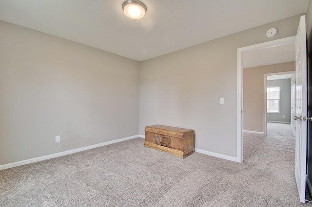 empty room with carpet floors and baseboards