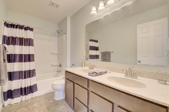 full bath with toilet, double vanity, visible vents, and a sink