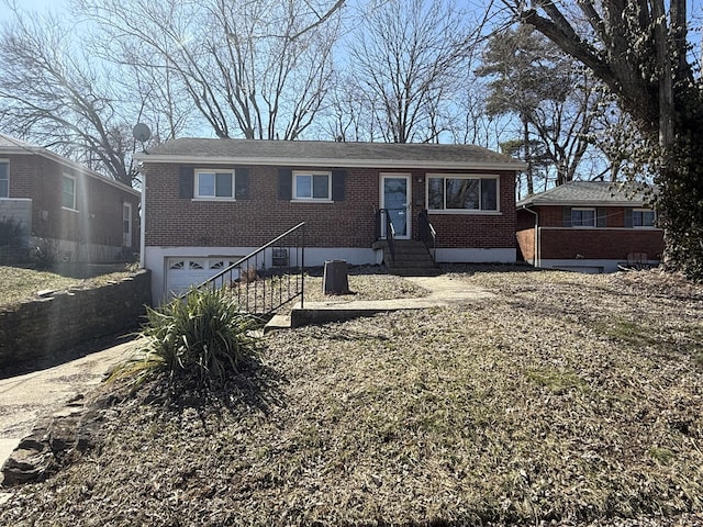 single story home featuring brick siding and an attached garage