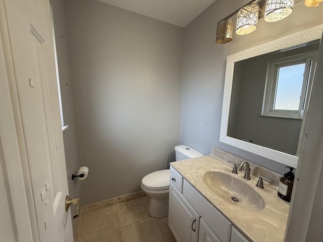 bathroom featuring tile patterned floors, toilet, vanity, and baseboards