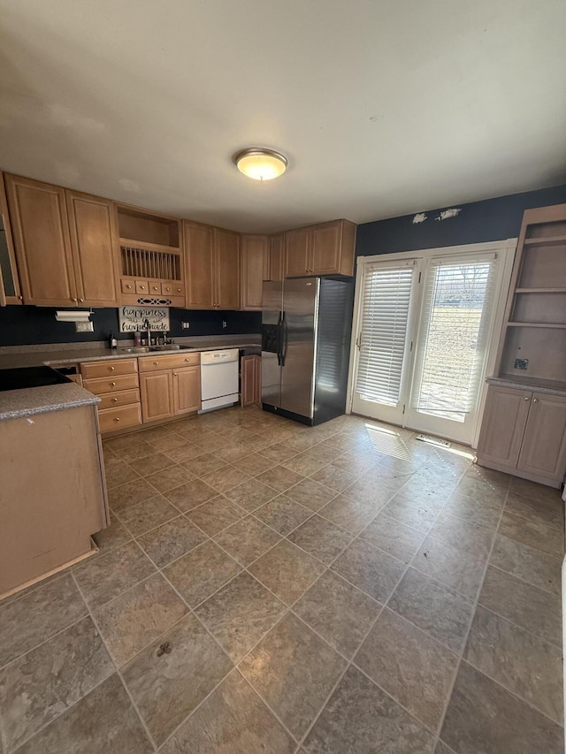 kitchen featuring open shelves, white dishwasher, stainless steel fridge with ice dispenser, and a sink