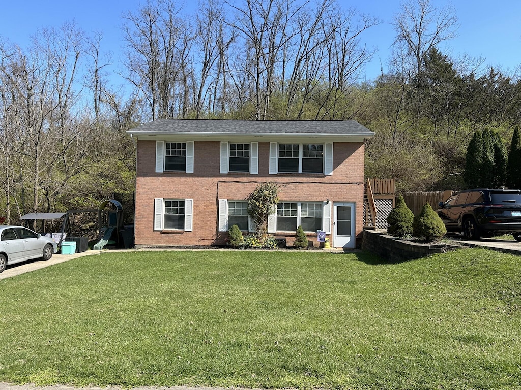 view of front of property with brick siding and a front yard