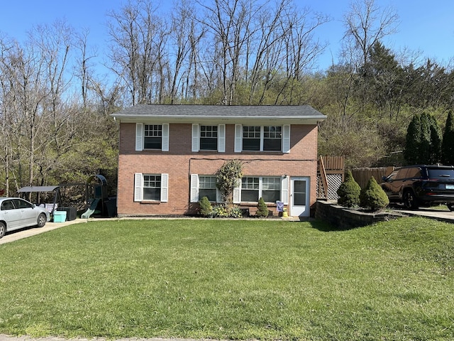 view of front of property with brick siding and a front yard