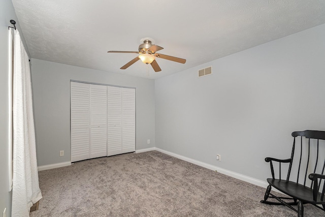 carpeted bedroom featuring a ceiling fan, baseboards, visible vents, and a closet