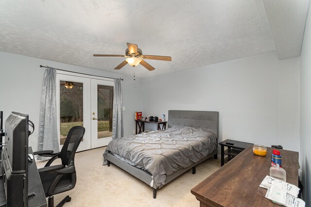 bedroom featuring a ceiling fan, light carpet, french doors, a textured ceiling, and access to outside