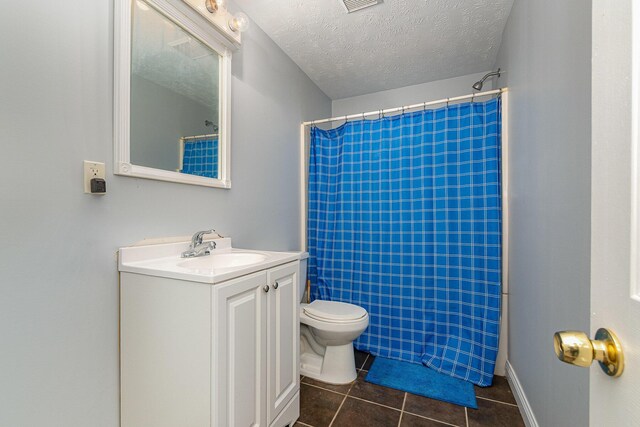 bathroom with visible vents, toilet, a textured ceiling, tile patterned flooring, and vanity