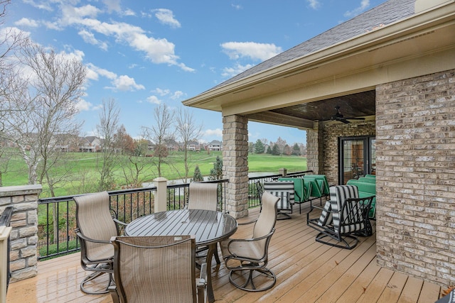 wooden terrace featuring outdoor lounge area, outdoor dining area, and a ceiling fan