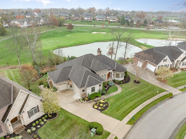 drone / aerial view featuring a water view and a residential view