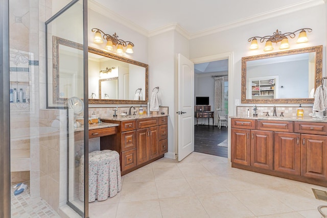 full bath featuring a sink, a stall shower, crown molding, and tile patterned flooring