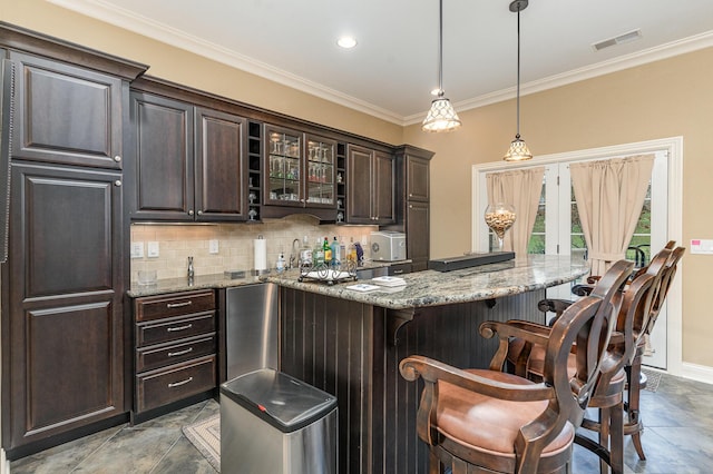 bar with visible vents, pendant lighting, backsplash, crown molding, and wet bar