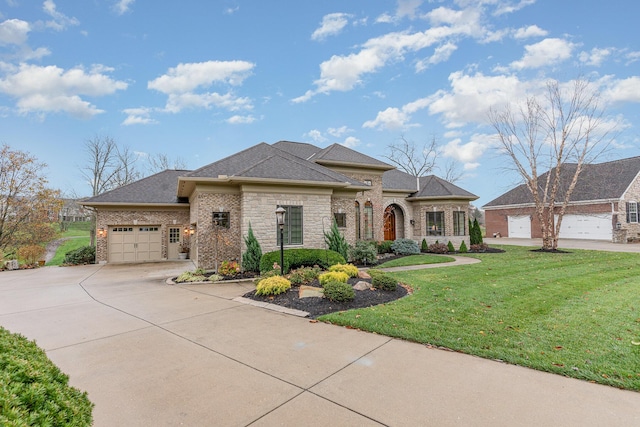 view of front of home with brick siding, an attached garage, concrete driveway, and a front lawn