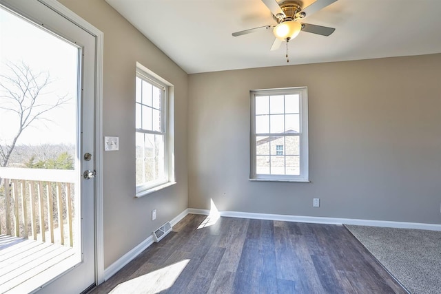 interior space featuring a wealth of natural light, dark wood-style floors, and baseboards