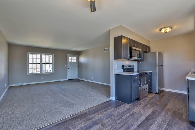 kitchen featuring stainless steel appliances, baseboards, visible vents, and light countertops