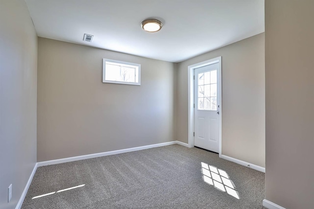 spare room with visible vents, baseboards, and carpet floors