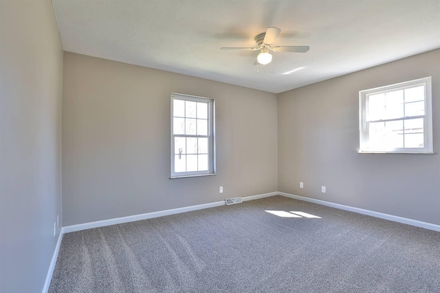 empty room with baseboards, carpet floors, and ceiling fan