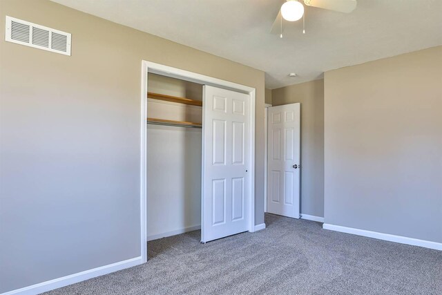 unfurnished bedroom featuring visible vents, baseboards, carpet, a closet, and a ceiling fan