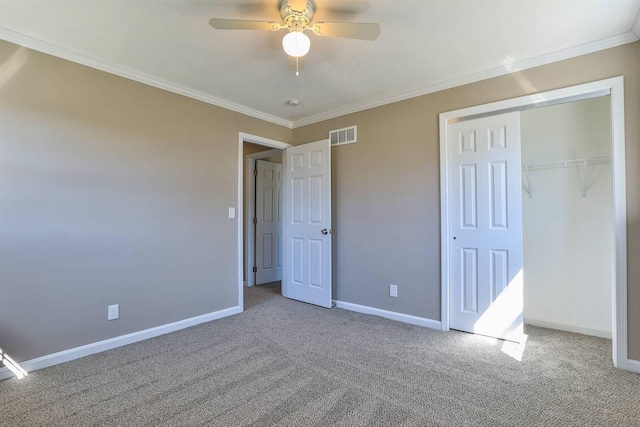 unfurnished bedroom with baseboards, visible vents, carpet floors, and ornamental molding