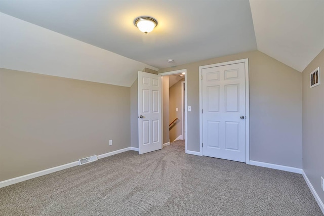 additional living space featuring visible vents, baseboards, and lofted ceiling