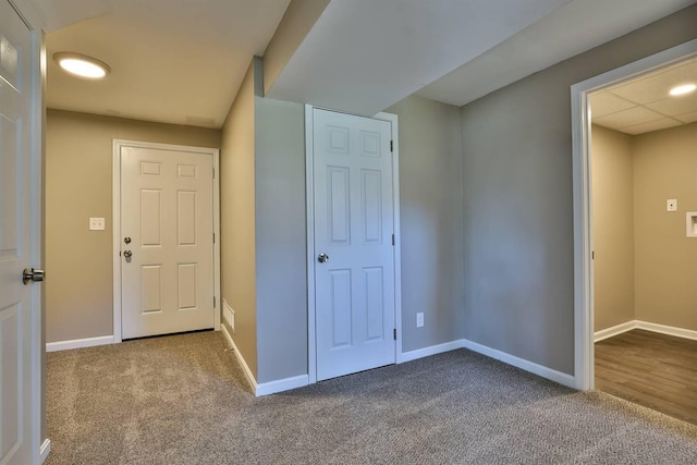 interior space featuring carpet flooring and baseboards