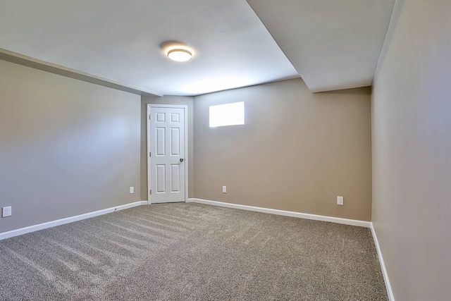 carpeted spare room with baseboards