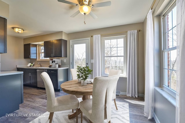 dining room with dark wood-style floors, ceiling fan, and baseboards