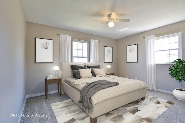 bedroom with light colored carpet, a ceiling fan, and baseboards